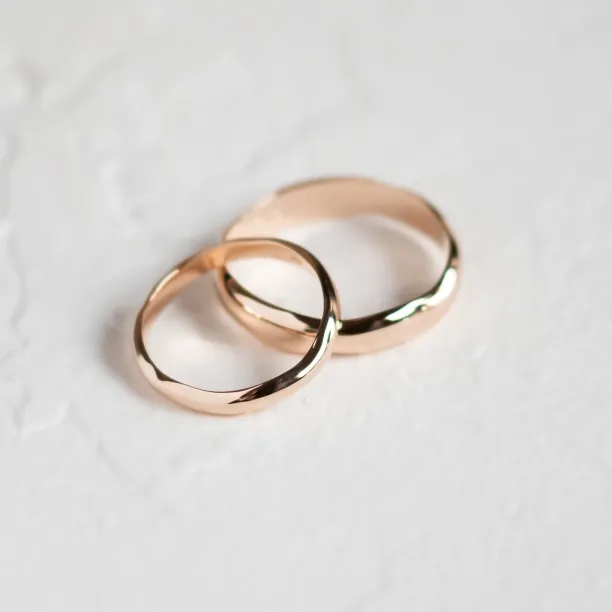 LUANA irregular gold wedding rings shown together in an angled close-up