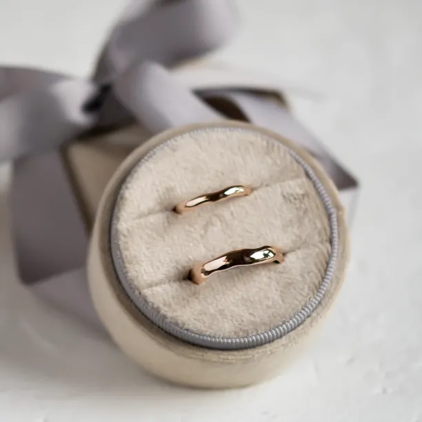 Pair of LUANA irregular gold wedding rings shown in close-up