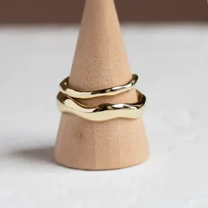 LUANA irregular gold wedding rings displayed together on a ring cone