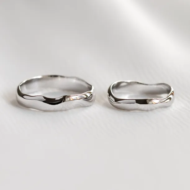LUANA irregular gold wedding rings shown as a pair