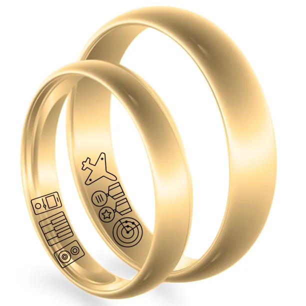 Angled view of gold wedding rings showing engraved symbols on the inner bands