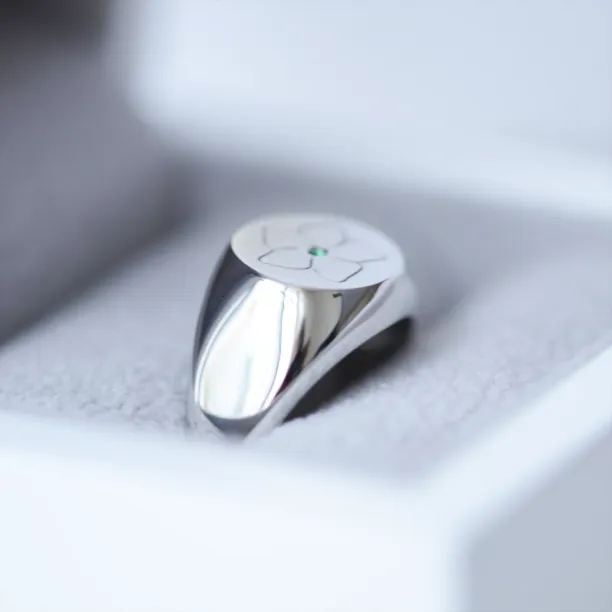 Angled side view of the CLARK men's gold ring with emerald and engraved top