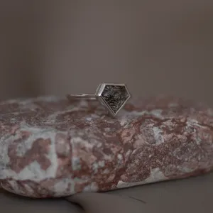 Angled view of the gold ALMONTE ring with rutile quartz on a stone