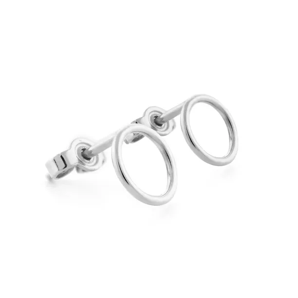 Angled close-up of the pair of silver karma earrings