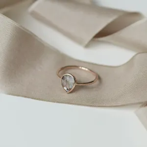 Angled view of the gold XENA ring and its salt and pepper diamond