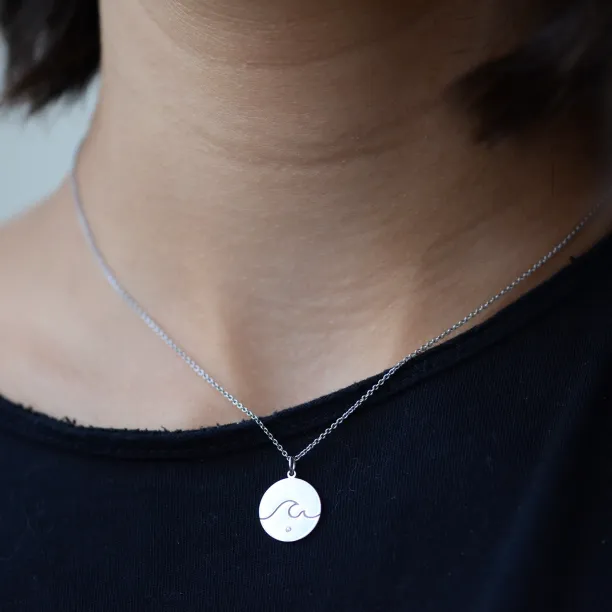 Gold pendant with a diamond SURF Image