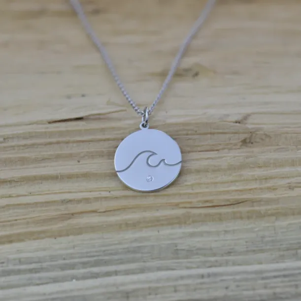Gold pendant with a diamond SURF Image