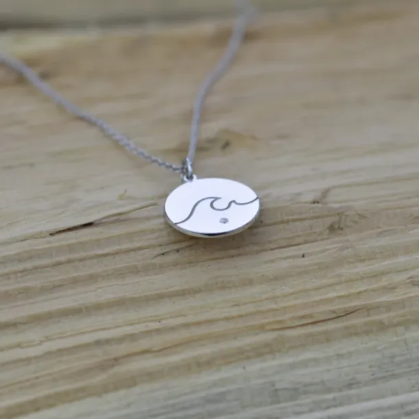 Gold pendant with a diamond SURF Image
