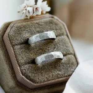 Angled view of BOME platinum wedding rings showing their textured bands