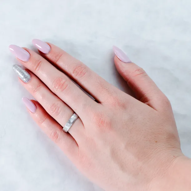 BOME platinum wedding ring worn on a hand, showing its textured band