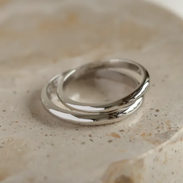 Close-up of overlapping platinum wedding rings