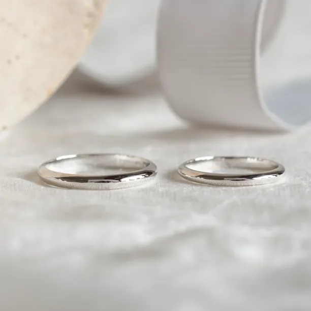 Pair of platinum wedding rings shown side by side