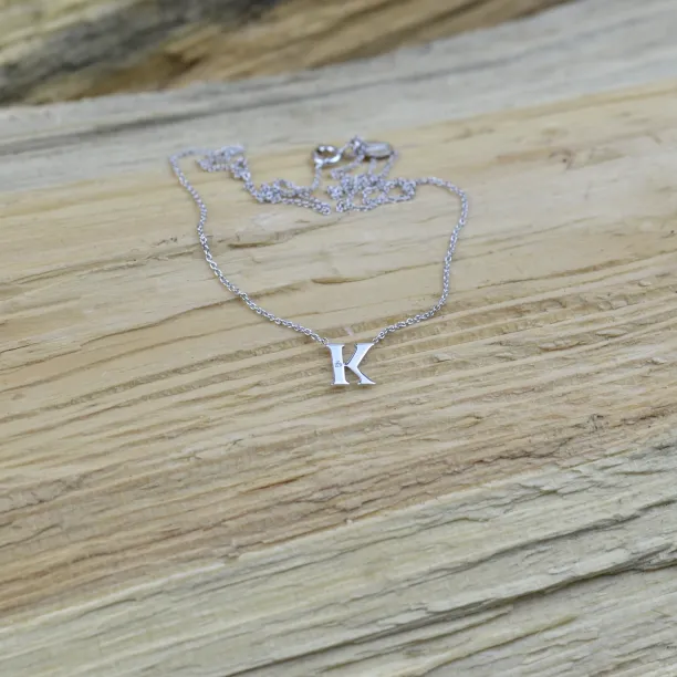 Full view of the VERTE silver letter K diamond necklace