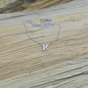 Full view of the VERTE silver letter K diamond necklace