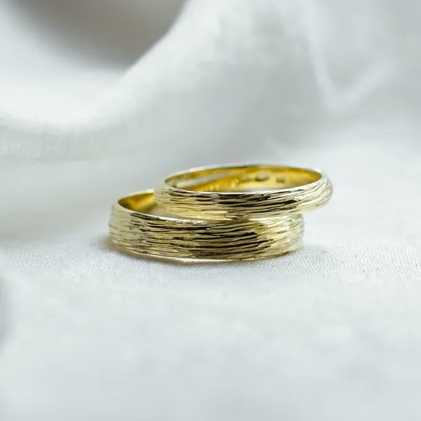DRIS gold wedding rings with textured, tree-inspired surfaces