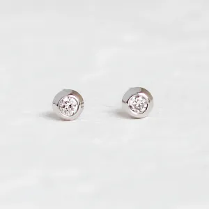 Pair of gold stud earrings with diamonds in a clear product view