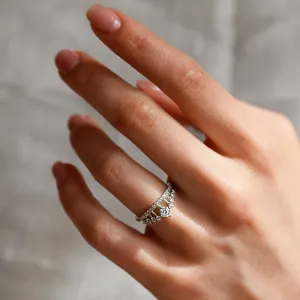 Detailní šikmý pohled na zásnubní prsten s diamanty ve tvaru korunky na ruce