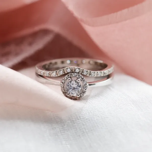 A gold ring with halo stones and diamonds HALOY Image