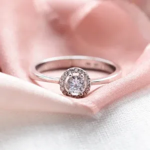 A gold ring with halo stones and diamonds HALOY Thumbnail