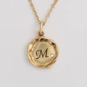 Close-up of the COLETTE diamond pendant with engraved M