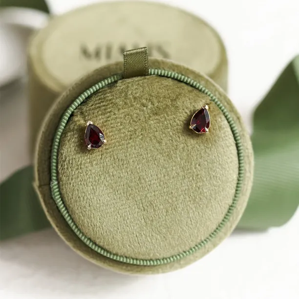 CARLIE gold earrings with pear-shaped garnets shown together in a wider view
