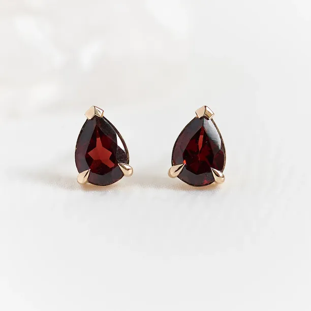 CARLIE gold earrings with pear-shaped garnets, shown as a matching pair