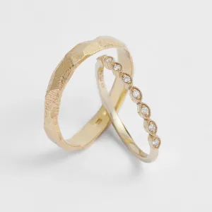 Interlocking DARLING diamond wedding bands with a textured surface
