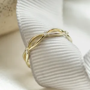 Angled close-up of the intertwined gold ring with diamonds
