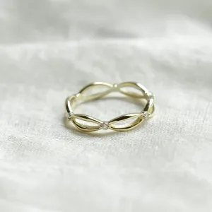 Gold diamond twisted ring with its interwoven design visible