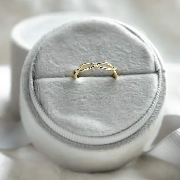 Gold diamond twisted ring in an angled display view