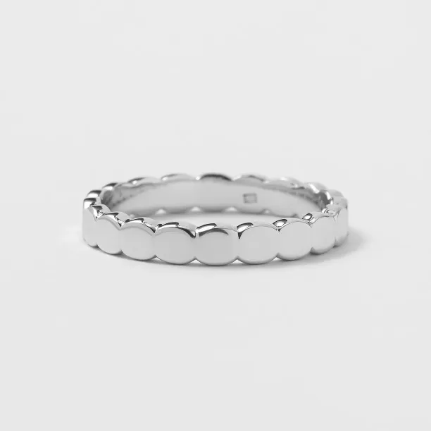 NOMA geometric wedding ring showing its organic textured surface and interior