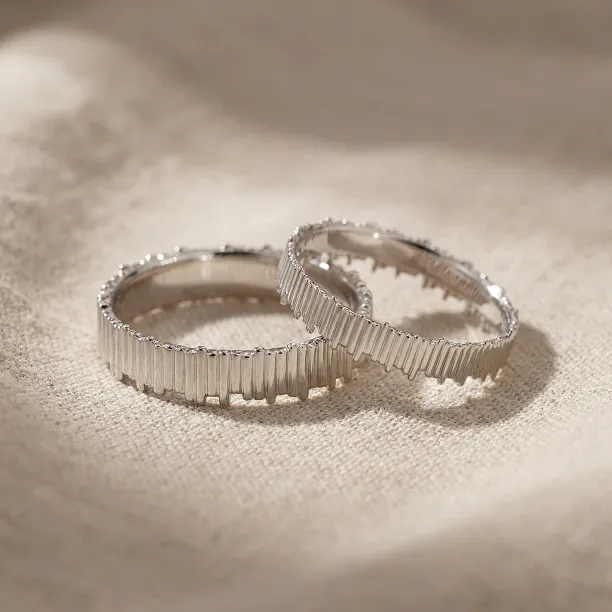 White gold VELA wedding rings with textured vertical lines