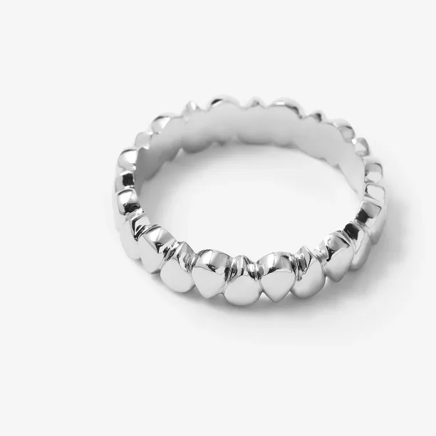 Close-up of a single EIRA geometric wedding ring with a textured surface