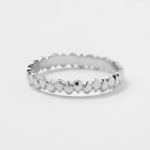 EIRA geometric wedding ring with a textured surface and repeating rounded forms