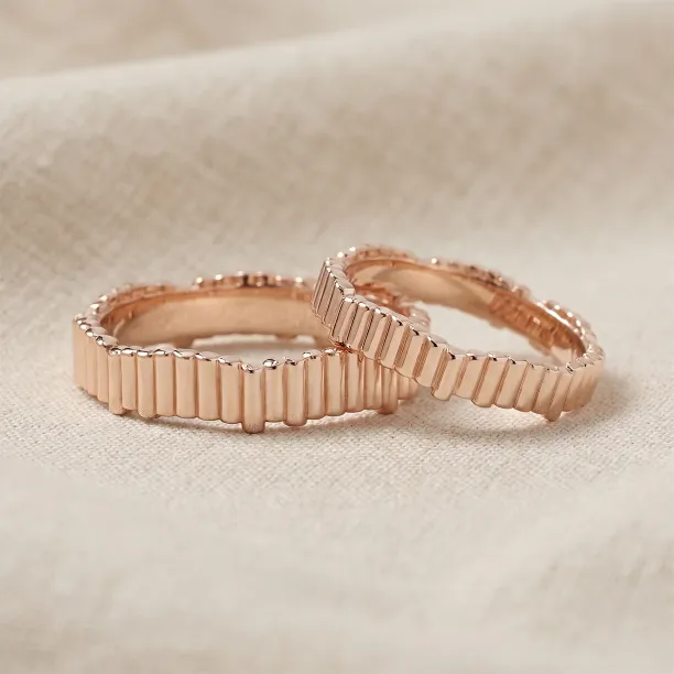 Rose gold geometric wedding rings INGRID in an angled view