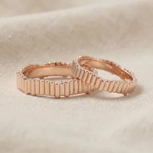 Rose gold geometric wedding rings INGRID in an angled view