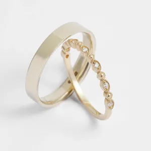 Angled view of HONEY wedding rings with a diamond eternity band