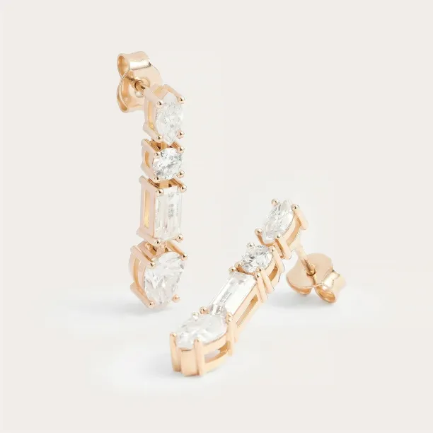 Angled view of MARINA dangle earrings with certified moissanites