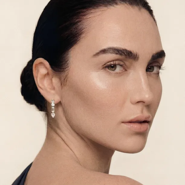 Side view of a MARINA dangle moissanite earring worn on the ear