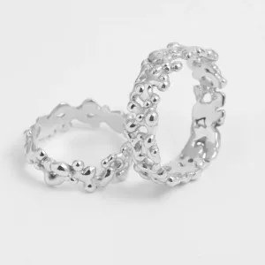 Angled view of NALANI wedding rings with organic elements