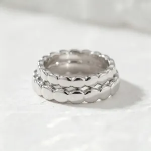 Close-up of stacked NOMA geometric wedding rings in 14K white gold