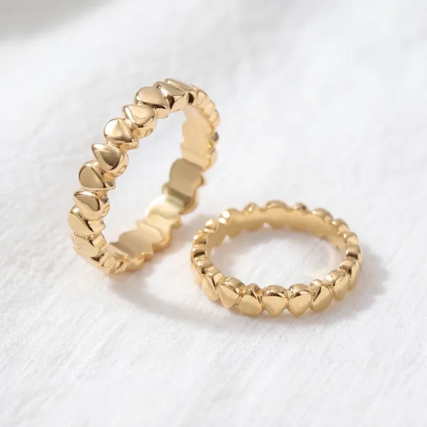 EIRA geometric wedding rings shown separately, highlighting their textured surfaces