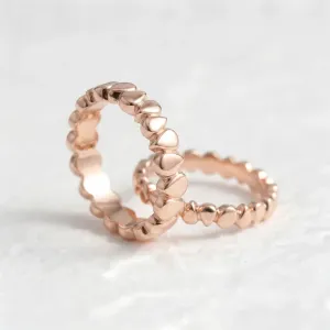 Angled view of a pair of EIRA geometric wedding rings