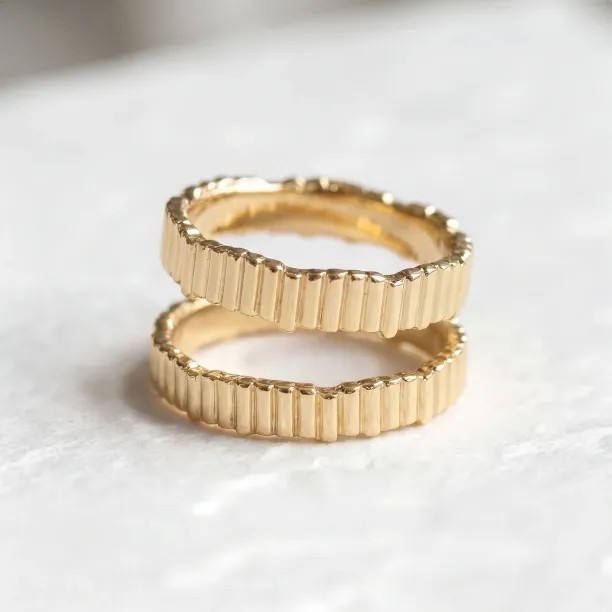 Geometric wedding rings INGRID shown from an angle with a segmented surface