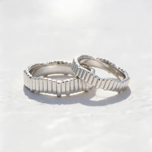 Geometric wedding rings INGRID shown together with their structured segmented surface