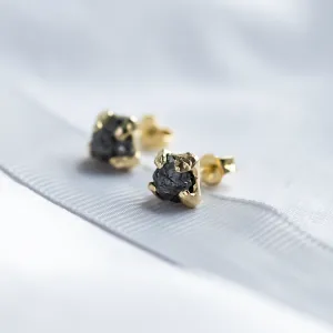 Angled close-up of CORDELIA earrings with natural untreated rough grey diamonds