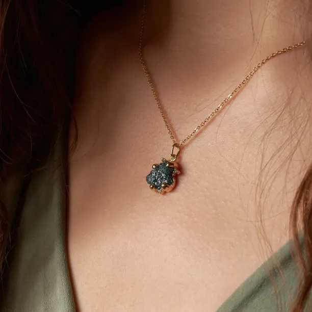 Close-up of the LAURA raw diamond pendant worn on the neck