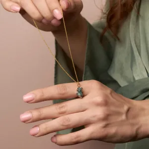 LAURA raw diamond pendant held above an open hand