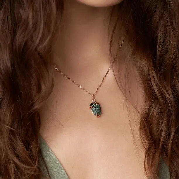 Angled view of LAURA raw diamond pendant worn on the neck