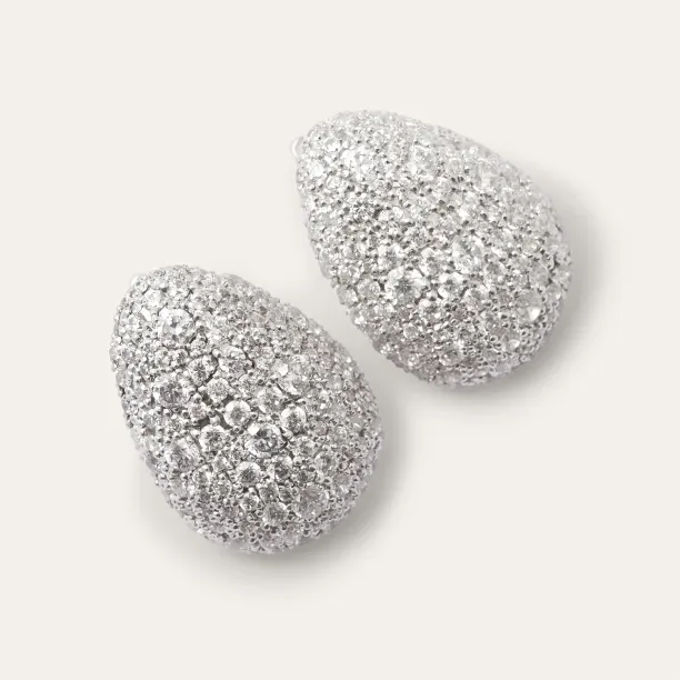 Pair of gold earrings with diamonds in an angled view